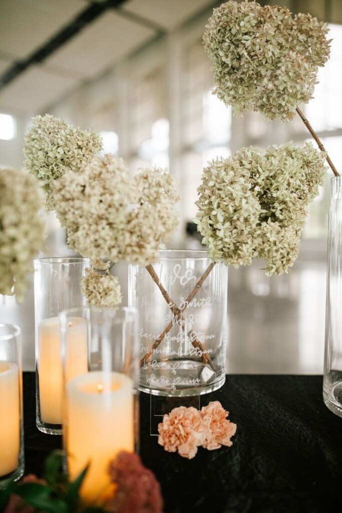 Several Vases With Flowers And Candles On A Table
